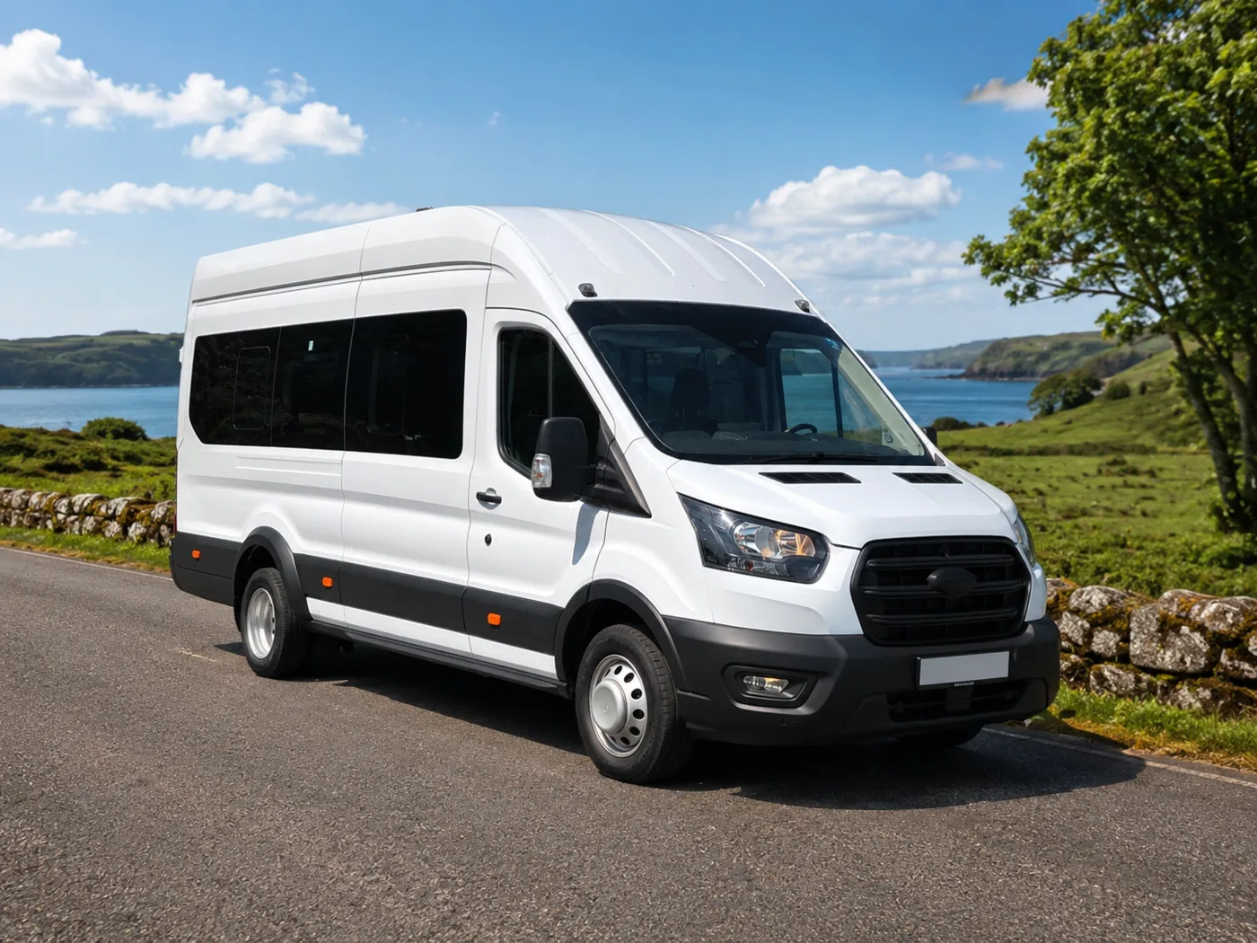 Modern white 16-seat minibus on a scenic Irish road